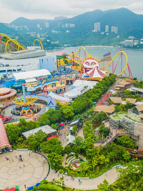 Aerial view of Ocean Park Theme Park with roller coasters and scenic bay in Hong Kong.