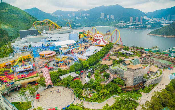Aerial view of Ocean Park Theme Park with roller coasters and scenic bay in Hong Kong.