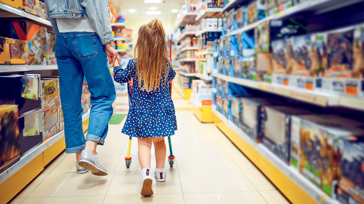 Parent and child shopping in a London toy store aisle.