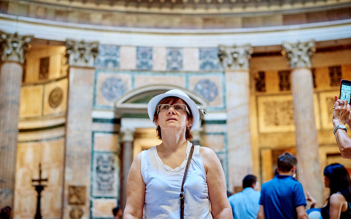 Visitor exploring the interior of the Pantheon during a guided tour in Rome.