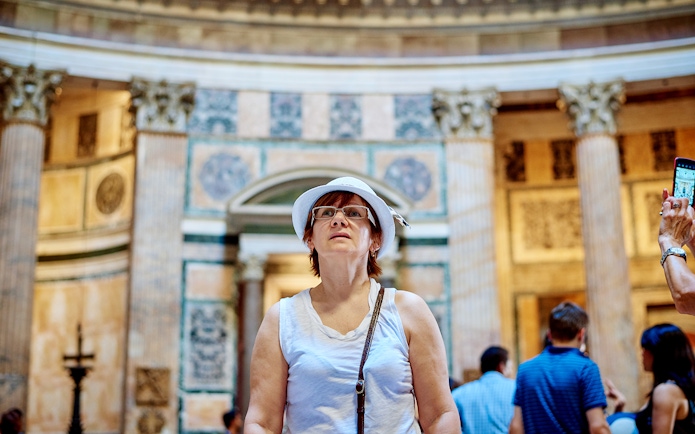 Visitor exploring the interior of the Pantheon during a guided tour in Rome.