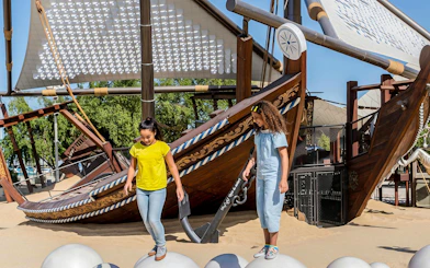 Children exploring a dhow exhibit at the National Museum of Qatar, Doha.
