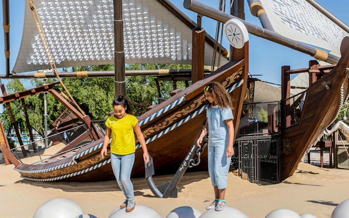 Children exploring a dhow exhibit at the National Museum of Qatar, Doha.