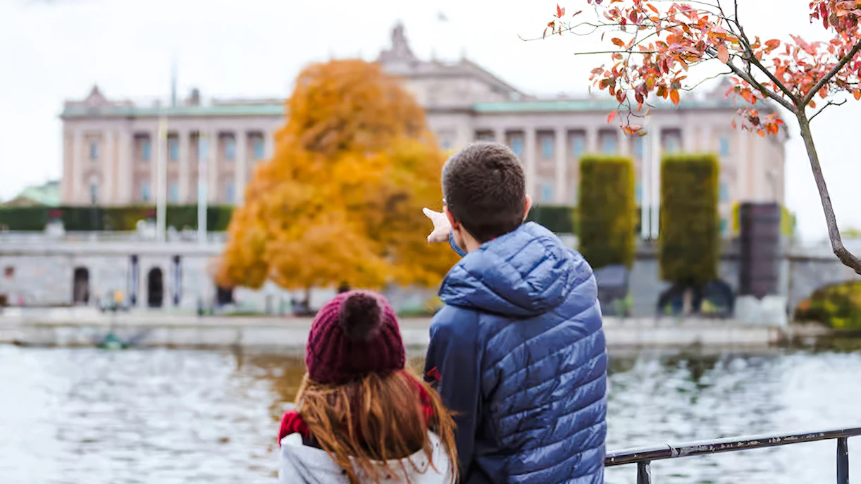 Couple admiring the Royal Palace in Stockholm from across the water.
