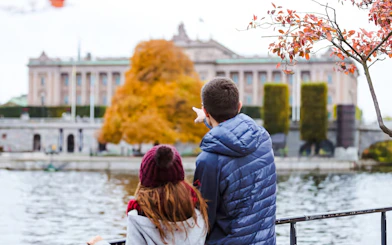 Couple admiring the Royal Palace in Stockholm from across the water.