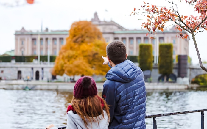 Couple admiring the Royal Palace in Stockholm from across the water.