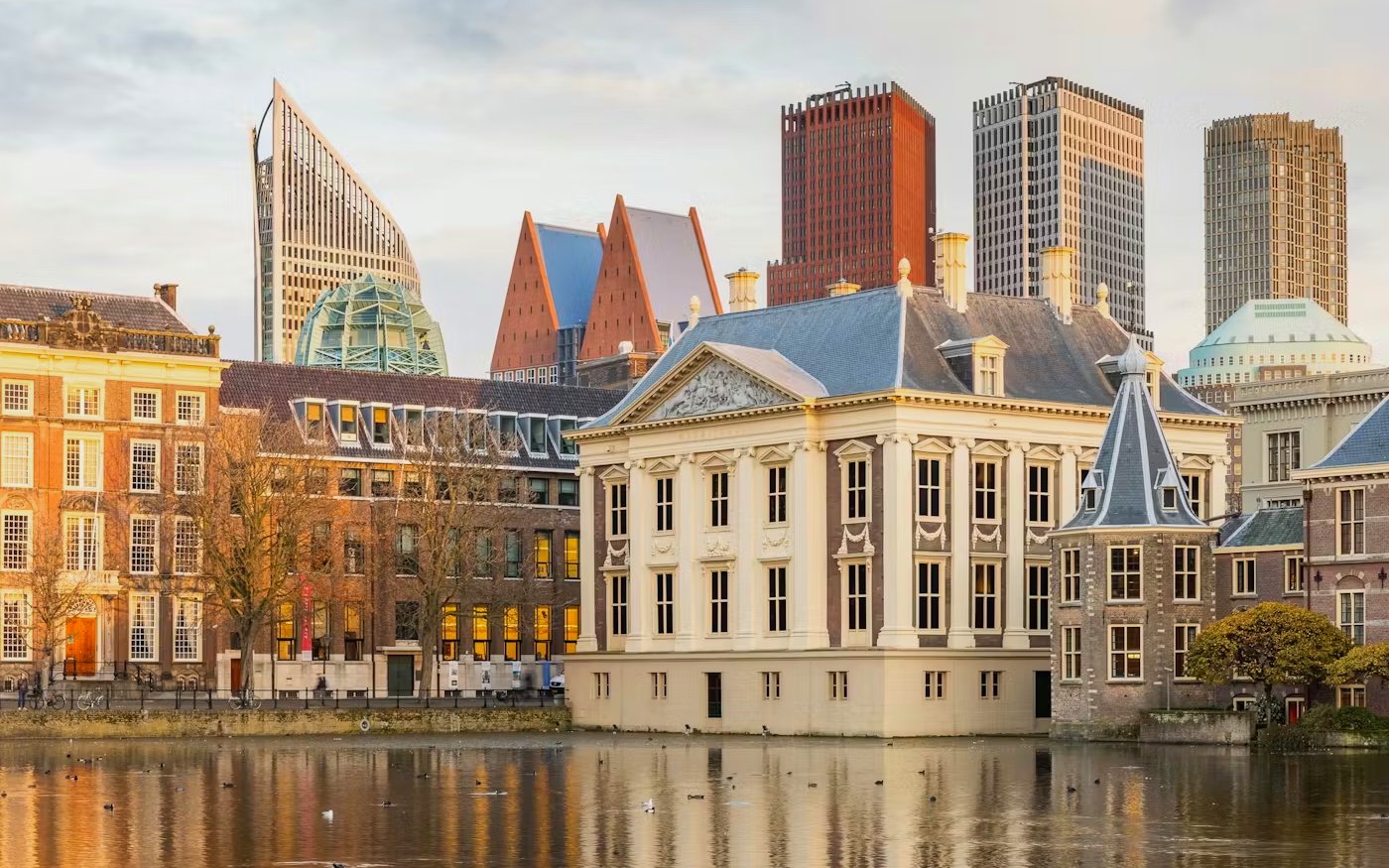 Mauritshuis museum in The Hague with modern city skyline in the background.