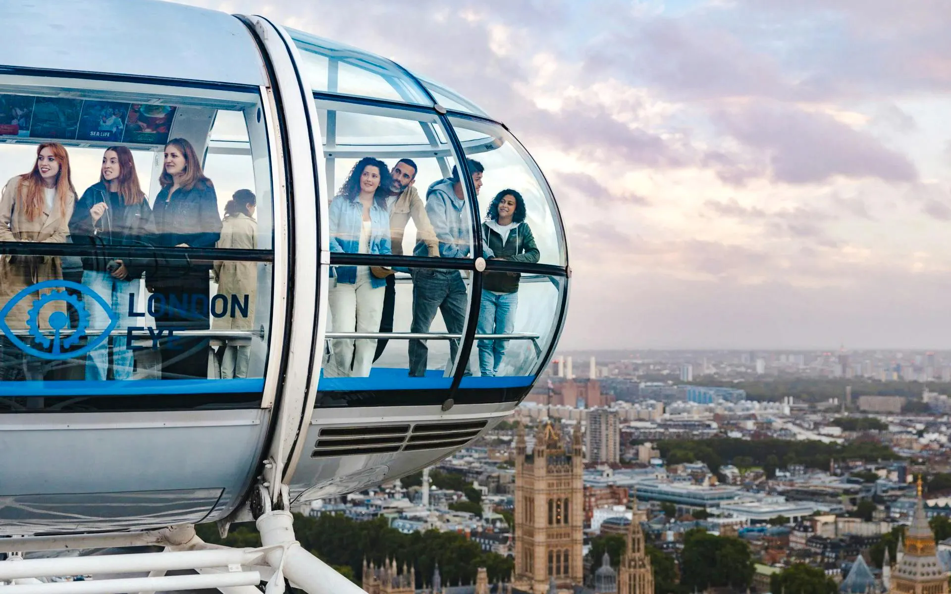 Guests enjoying views from the London Eye capsule over the city skyline.