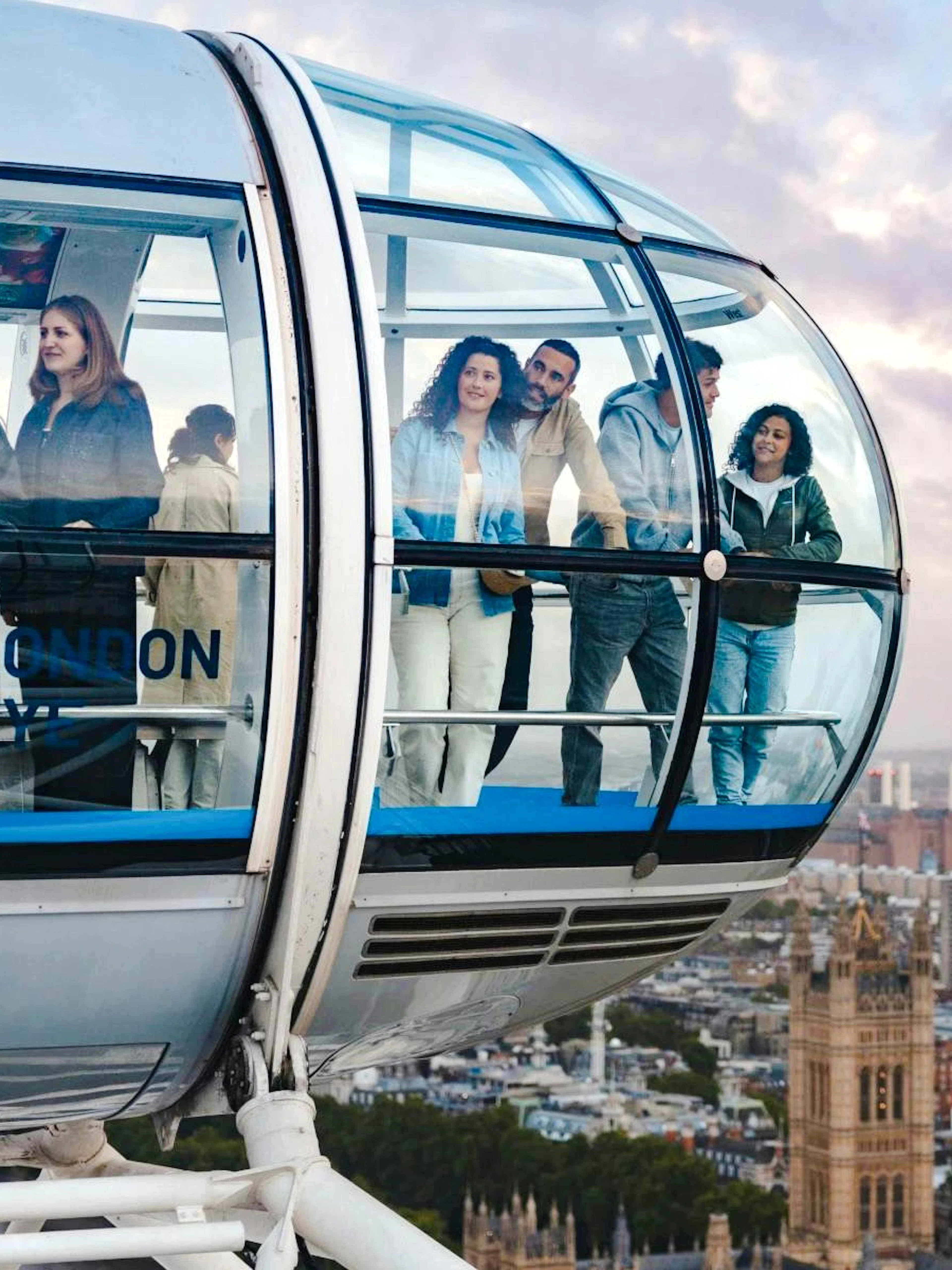 Guests enjoying views from the London Eye capsule over the city skyline.