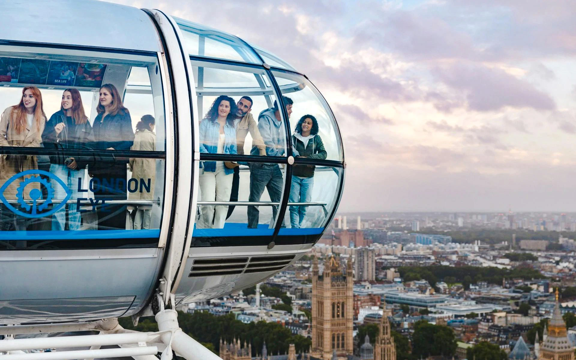 Guests enjoying views from the London Eye capsule over the city skyline.