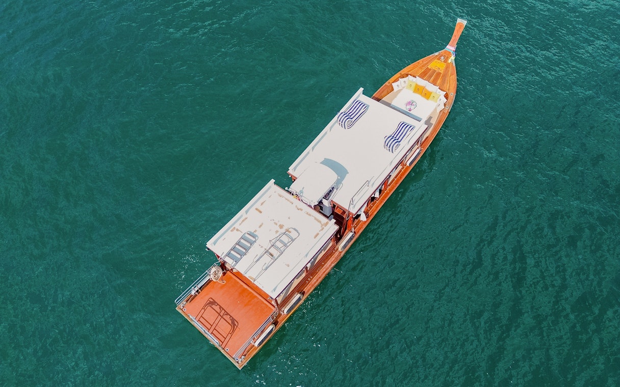 Long tail boat on turquoise water en route to Ko Hong, Thailand.