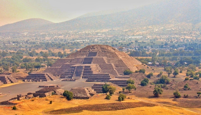 Teotihuacan Pyramid of the Moon with tourists exploring the ancient site in Mexico.