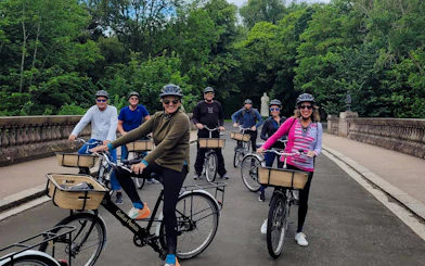 Guests cycling on a scenic path during the Glasgow Highlights Bike Tour.
