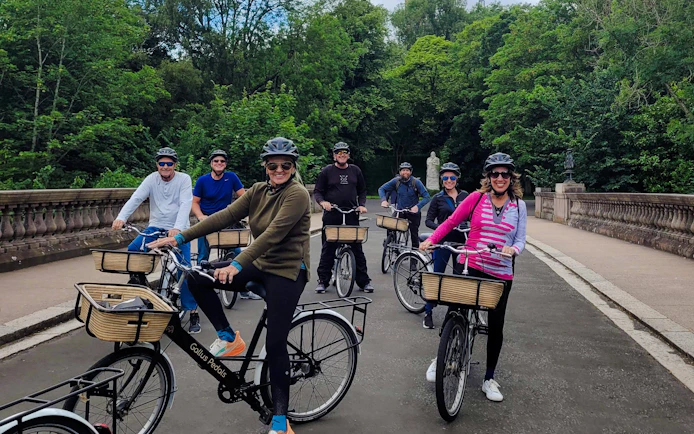 Guests cycling on a scenic path during the Glasgow Highlights Bike Tour.