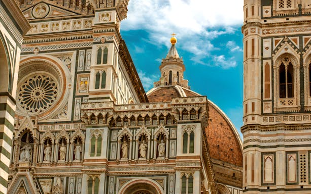 Florence Cathedral facade and dome on a sunny day, part of a full-day tour from Rome.