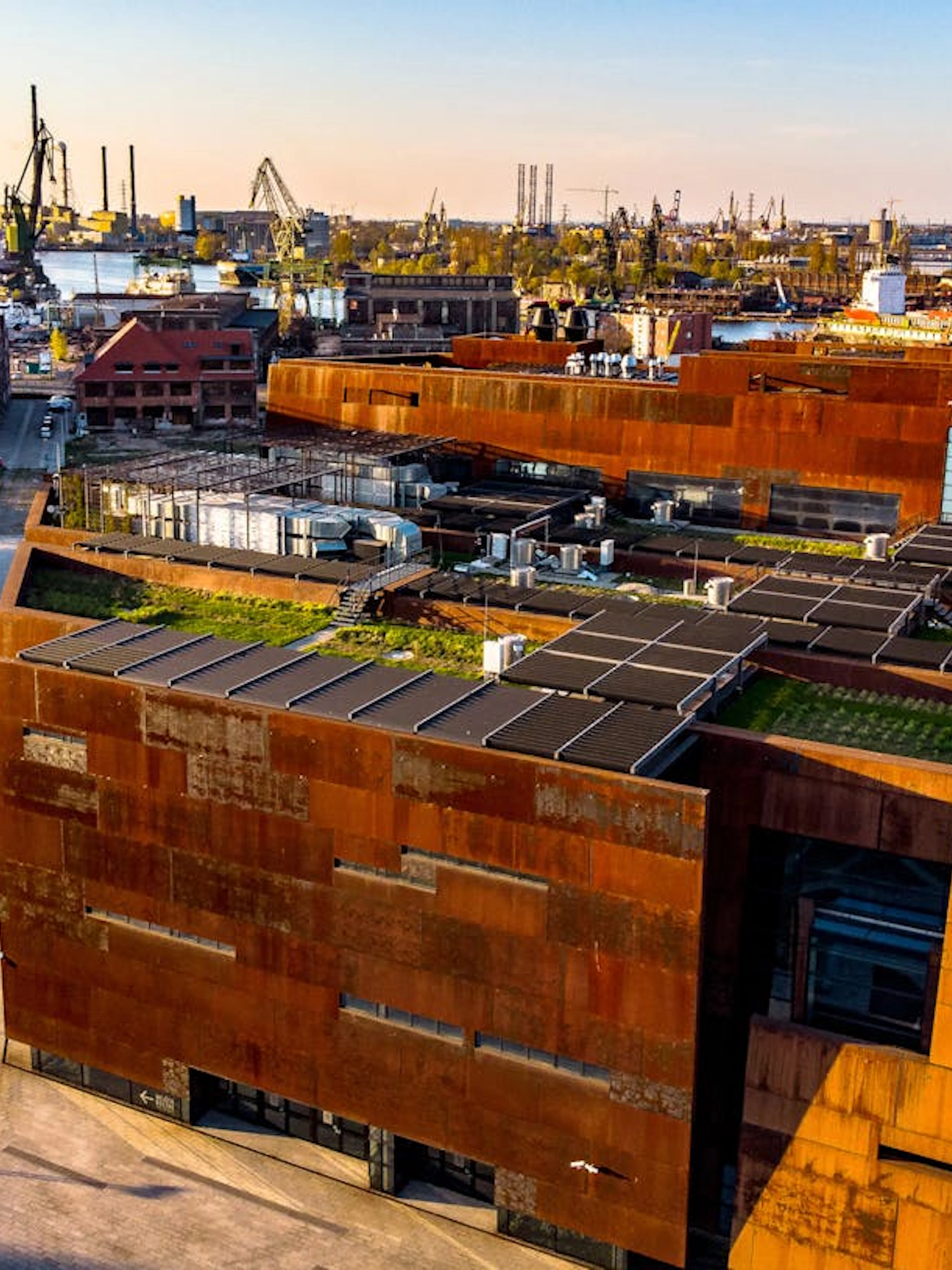 European Solidarity Centre exterior with shipyard cranes in Gdańsk, Poland.