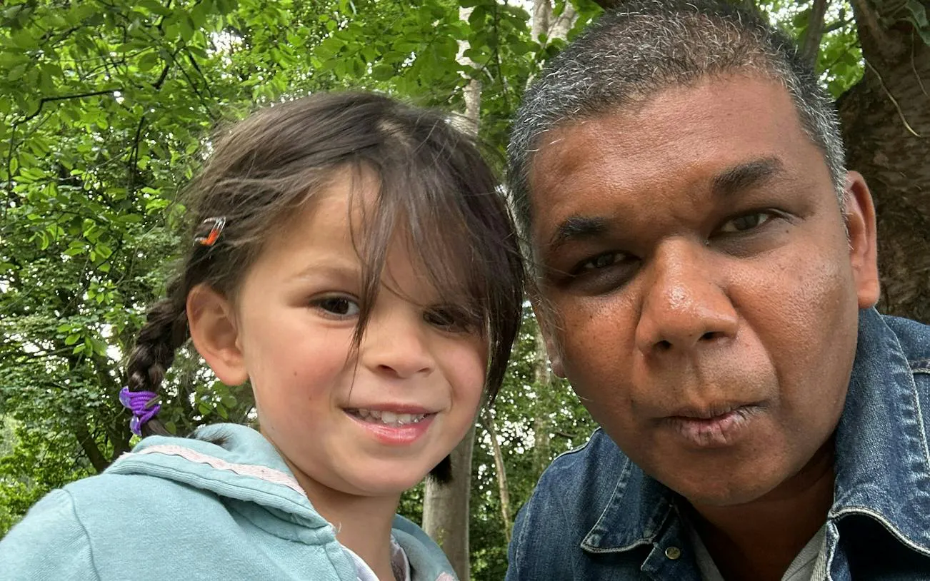 Father and child enjoying Dublin Kid Quest Lost Senses game in a lush park setting.