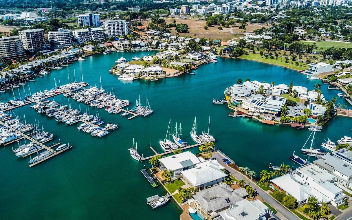 Aerial view of Darwin marina with boats and waterfront homes, part of Big Bus Darwin tour.