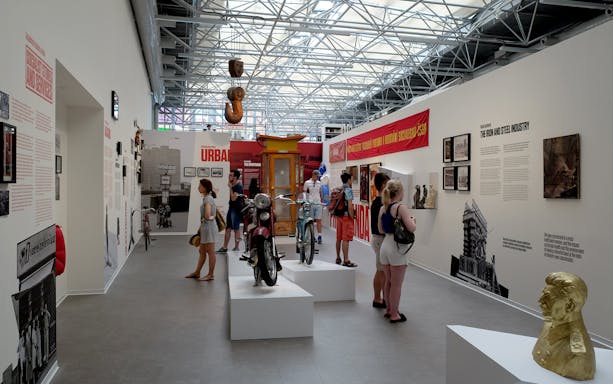 Visitors exploring exhibits at the Museum of Communism in Prague, featuring historical artifacts and displays.