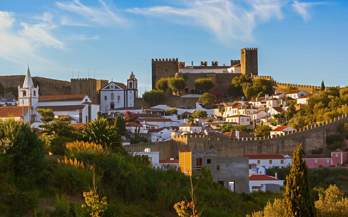 Óbidos townscape with medieval castle and whitewashed houses in Portugal.