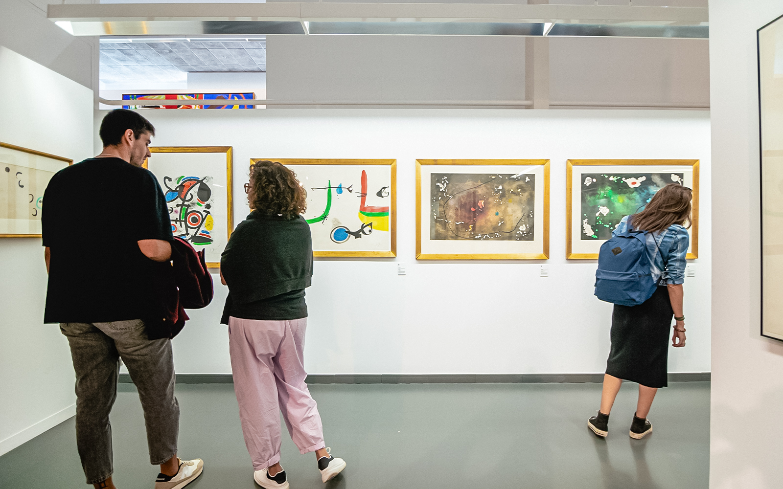 Visitors exploring art exhibition inside Poble Espanyol, Barcelona.