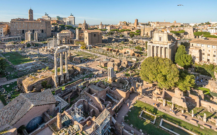 Roman Forum ruins with ancient columns and structures in Rome.