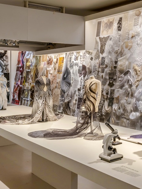 ArtScience Museum exhibit with fashion designs and microscopes on display.
