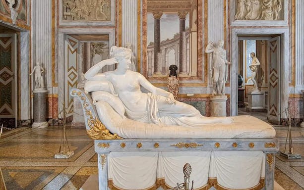 Venus Victrix statue in Borghese Gallery, Rome, showcasing neoclassical art.