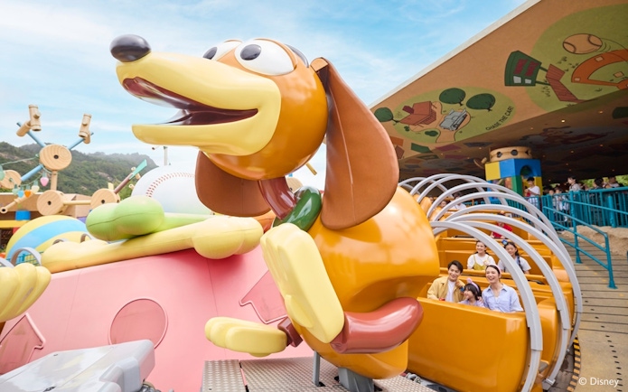 Slinky Dog Spin Ride with tourists at Disneyland Hong Kong.