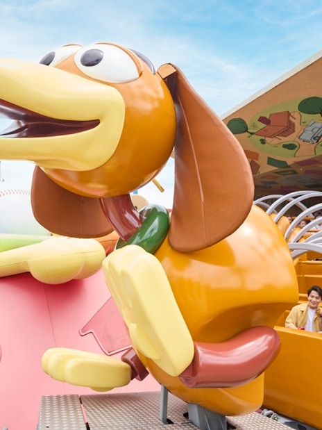 Slinky Dog Spin Ride with tourists at Disneyland Hong Kong.