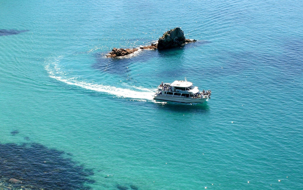 Cruise boat near Cape Woolamai rock formations, Phillip Island.