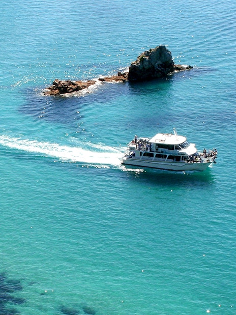 Cruise boat near Cape Woolamai rock formations, Phillip Island.