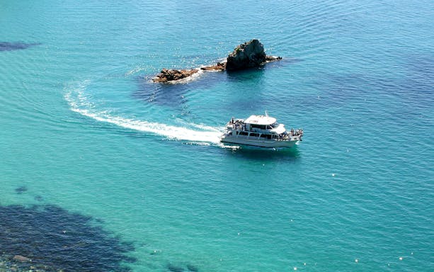 Cruise boat near Cape Woolamai rock formations, Phillip Island.