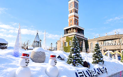 Snow-covered Shiroi Koibito Park with snowmen and clock tower in Sapporo, Hokkaido.