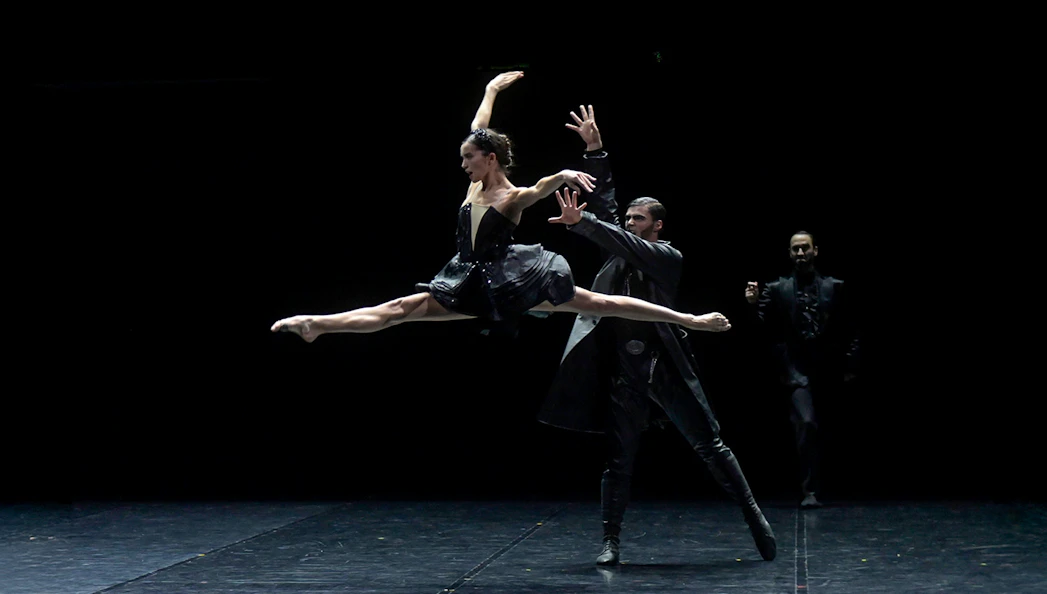 Ballet dancers performing Preljocaj's Swan Lake on stage.