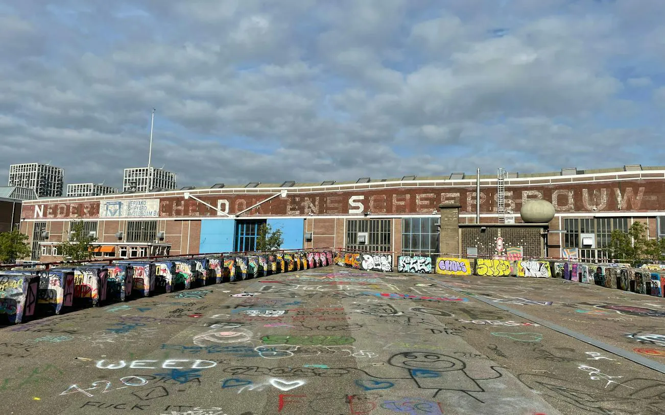 Graffiti-covered shipyard in Amsterdam, part of the Ship-Sinking Secret self-guided city exploration game.