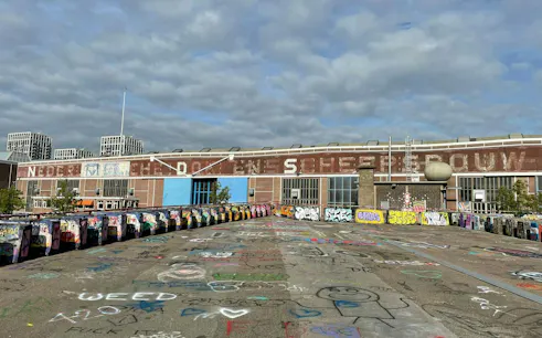 Graffiti-covered shipyard in Amsterdam, part of the Ship-Sinking Secret self-guided city exploration game.