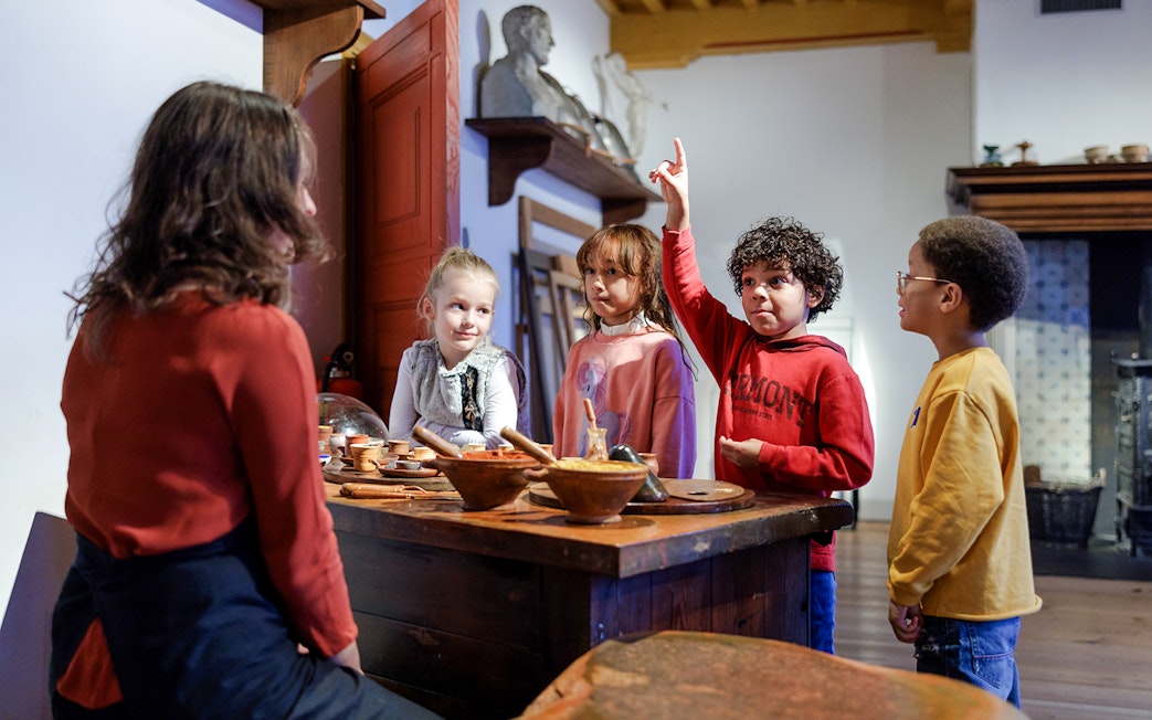 Children engaging with a guide at Rembrandt House Museum, Amsterdam.
