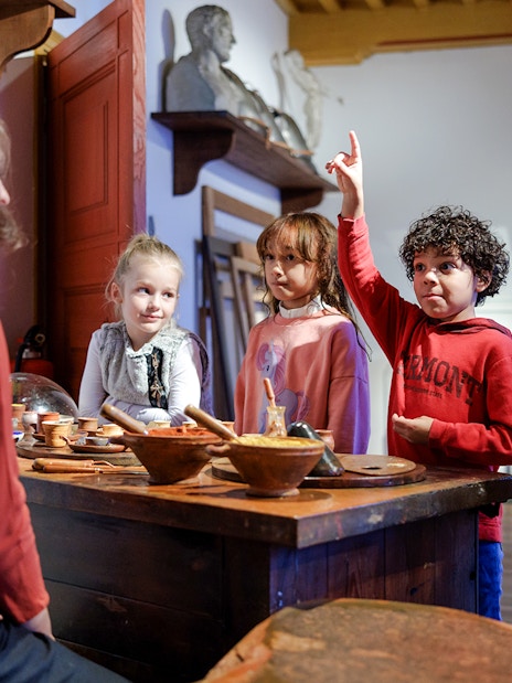 Children engaging with a guide at Rembrandt House Museum, Amsterdam.