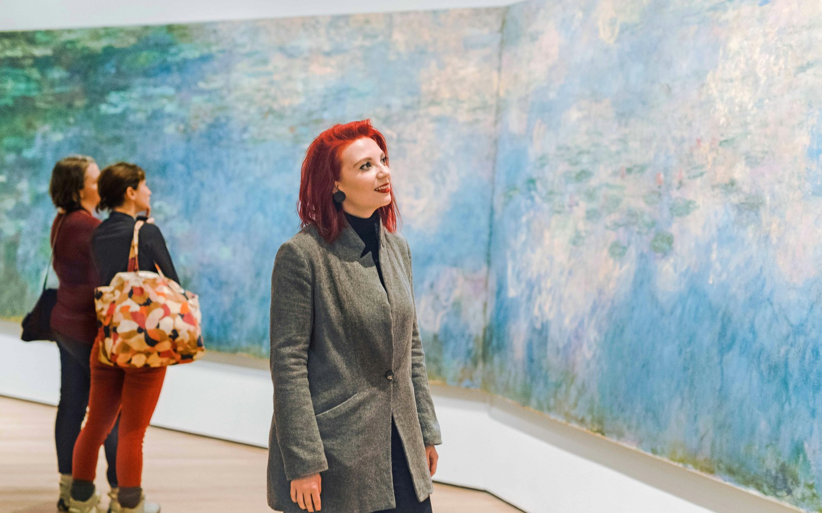 Visitors admiring Monet's Water Lilies at the Museum of Modern Art (MoMA).