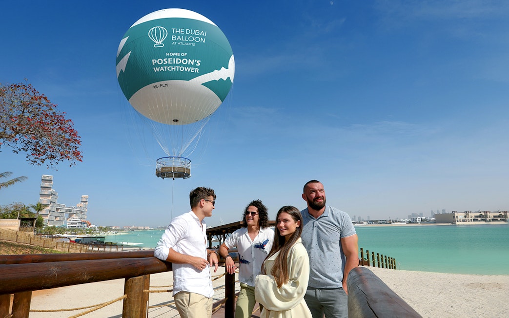 The Dubai Balloon at Atlantis with tourists enjoying the view by the waterfront.