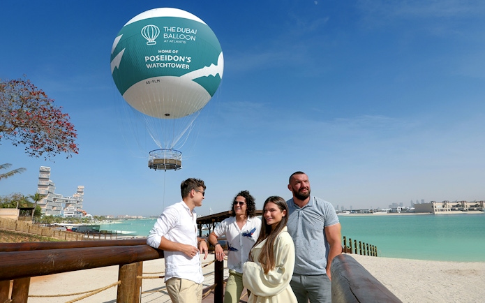 The Dubai Balloon at Atlantis with tourists enjoying the view by the waterfront.