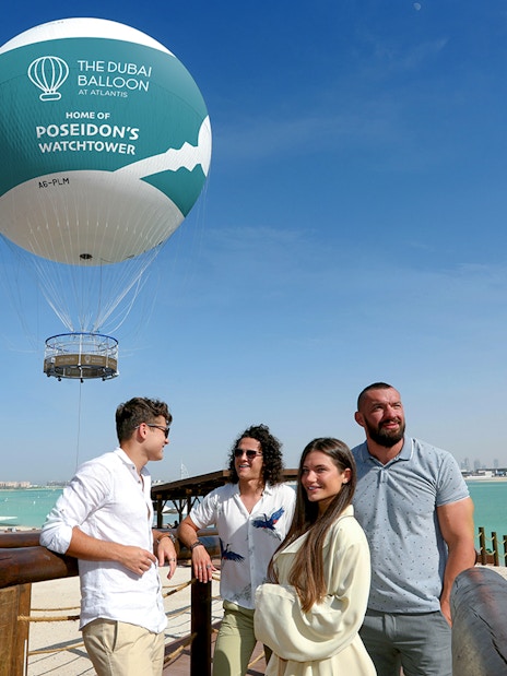 The Dubai Balloon at Atlantis with tourists enjoying the view by the waterfront.