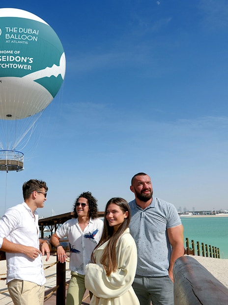 The Dubai Balloon at Atlantis with tourists enjoying the view by the waterfront.