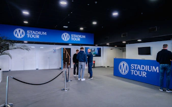 OM Guided Tour entrance at CEPAC Vélodrome with visitors gathering.