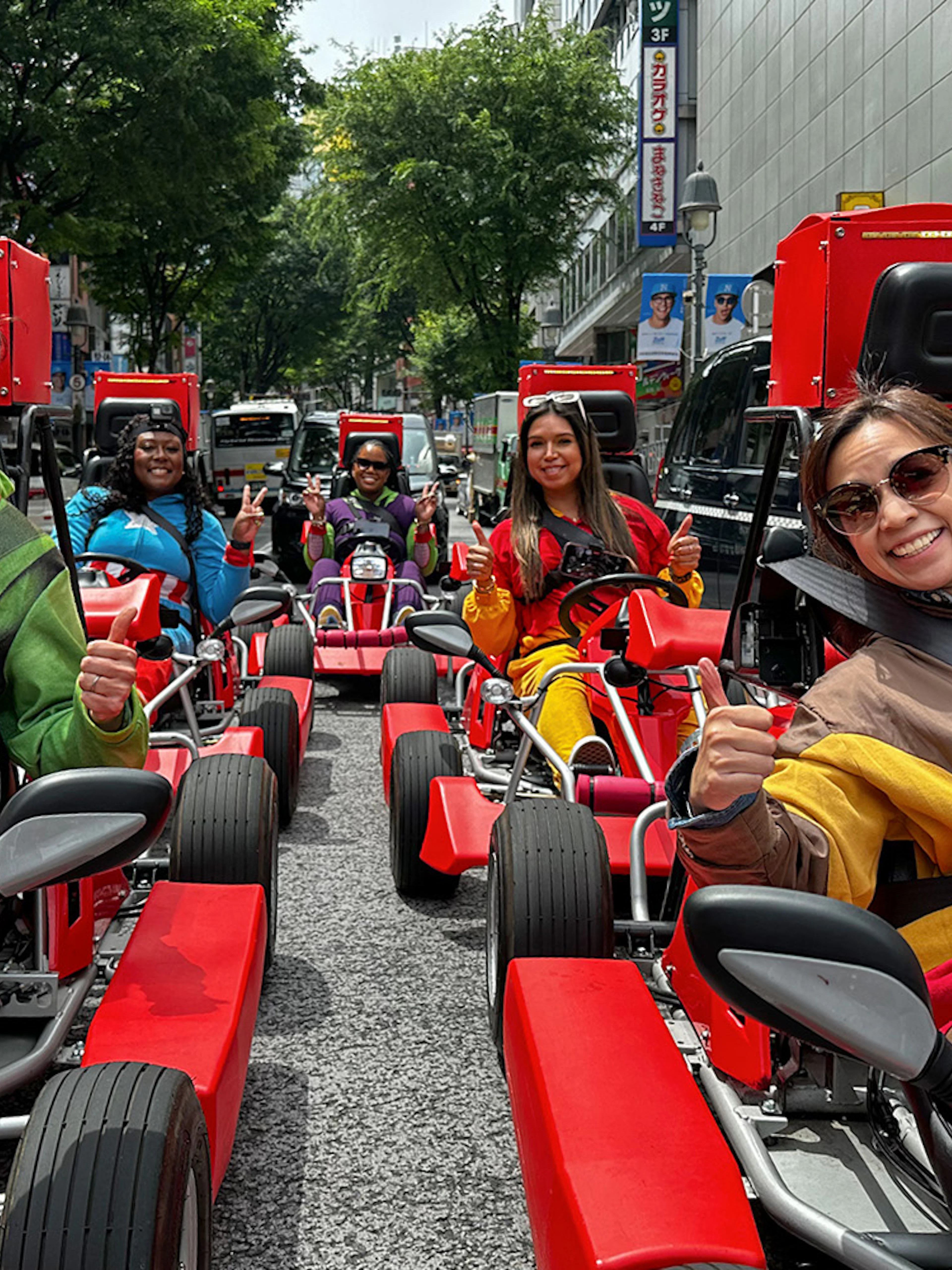 People in costumes driving go-karts on a Shibuya street during a 1-hour tour.