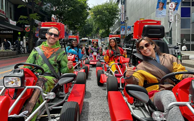 People in costumes driving go-karts on a Shibuya street during a 1-hour tour.