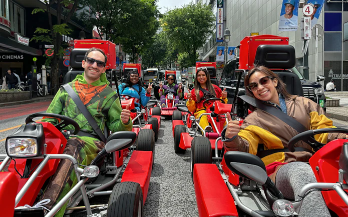 People in costumes driving go-karts on a Shibuya street during a 1-hour tour.