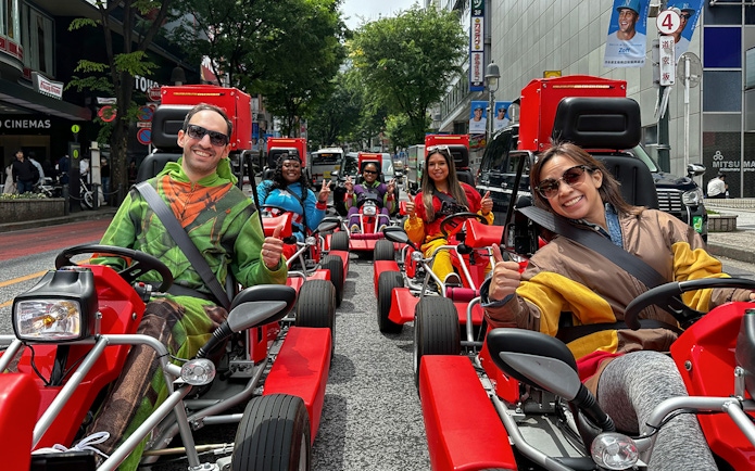 People in costumes driving go-karts on a Shibuya street during a 1-hour tour.