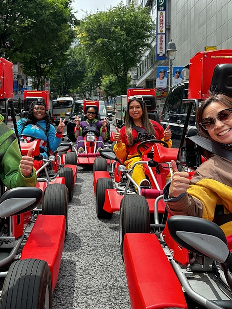 People in costumes driving go-karts on a Shibuya street during a 1-hour tour.